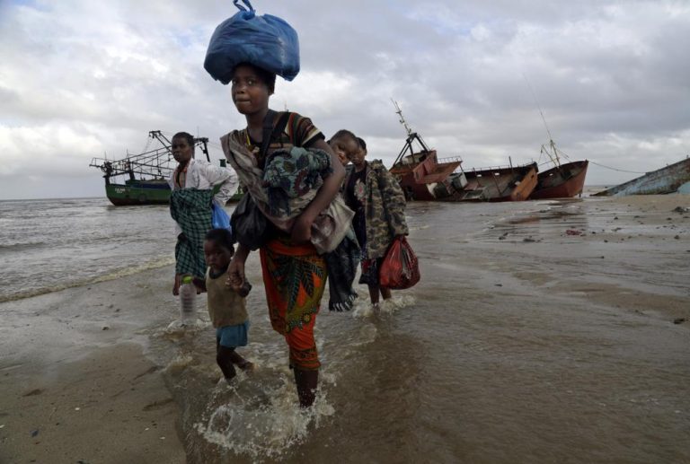 FILE — In this Saturday, March 23, 2019 file photo, displaced families arrive after being rescued by boat from a flooded area of Buzi district, 200 kilometers (120 miles) outside Beira, Mozambique. The U.N. high commissioner for refugees, Filippo Grandi said Friday June 17, 2021, that conflicts and the impact of climate change in places like Mozambique were among the leading sources of new flows of refugees and internally displaced people in 2020. (AP Photo/Tsvangirayi Mukwazhi, File)