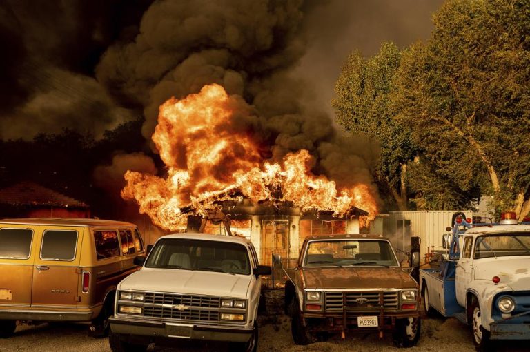 July 10, 2021 file photo, flames consume a home as the Sugar Fire, part of the Beckwourth Complex Fire, tears through Doyle, Calif. Pushed by heavy winds amid a heat wave, the fire came out of the hills and destroyed multiple residences in central Doyle. (AP Photo/Noah Berger)